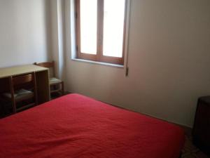 サンターガタ・ディ・ミリテッロにあるHoliday22sicilyのベッドルーム1室(赤いベッド1台、窓付)