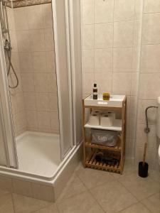 łazienka z prysznicem i półką z ręcznikami w obiekcie Apartmán Nahoře w mieście Vacov