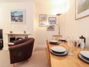 a dining room with a wooden table and a chair at Archers in Keswick