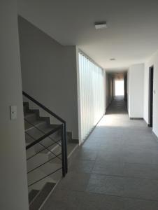 a hallway with a staircase in a building at Las Amapolas Jujuy in San Salvador de Jujuy