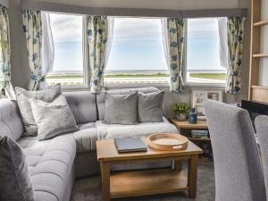 a living room with a couch and a table at Sea View Lodge in Heysham