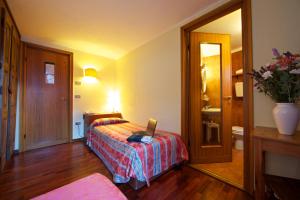 Postel nebo postele na pokoji v ubytování Hotel Dolonne