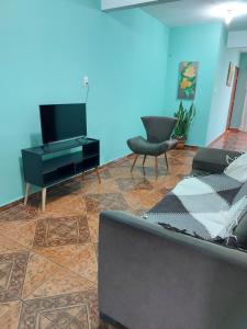 salon z kanapą i telewizorem z płaskim ekranem w obiekcie Triunfo Flat w mieście Triunfo
