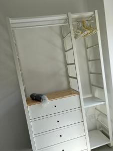 a white closet with white drawers and a ladder at CASAMALFITANA I DOGI in Maiori