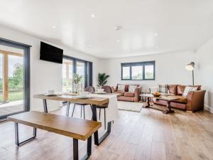 a living room with a couch and a table at Oak Tree Lodge - Uk38383 in Lyonshall