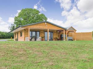 a log home with a large yard at Oak Tree Lodge - Uk38383 in Lyonshall