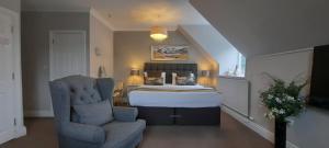 1 dormitorio con 1 cama y 1 silla en una habitación en Rocklea Guest House, en Windermere