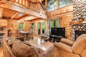 a living room with a couch and a television in a cabin at Bear Pleasures in Gatlinburg