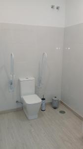 a white bathroom with a toilet in a room at Fonte dos aloques in Porriño