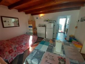 a kitchen with a bed and a table in a room at Casetta Miracoli Salento in Tuglie