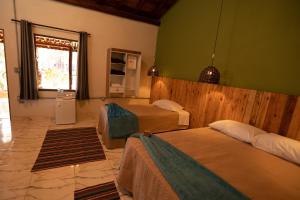 Ein Bett oder Betten in einem Zimmer der Unterkunft Pousada Pitauá
