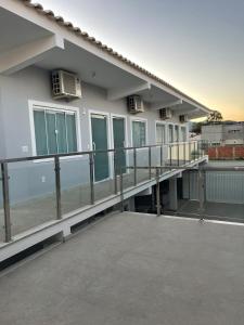 a balcony of a house with a lot of windows at Escalada Hospedagens e Eventos in Mucugê