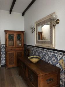 a bathroom with a mirror and a wooden cabinet at CASA AYARAN in Baeza