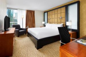 a hotel room with a bed and a desk at Millennium Hotel Broadway Times Square in New York
