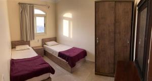 A bed or beds in a room at Bahga Palace 4 Residential Apartments
