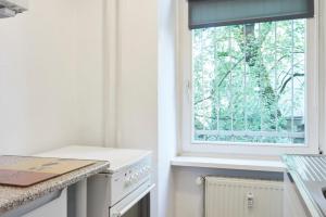 a kitchen with a window and a white stove at TOP SPOT MITTE . THE PLACE TO BE ! in Berlin