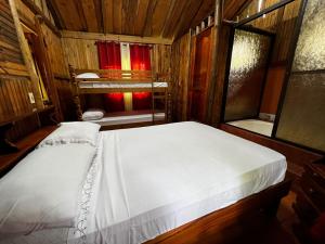 1 dormitorio con 1 cama en una habitación de madera en CABAÑA EL CEDRO, en San Vito