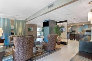 a lobby of a hotel with chairs and a bar at Best Western Plus Tallahassee North Hotel in Tallahassee