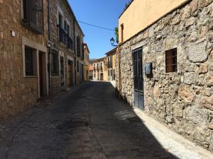 an empty street in an old stone building at Casa del Puente - MurallaHomes in Ávila