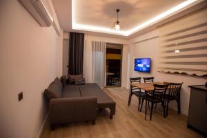 a living room with a couch and a table at Eva Apart Kemer in Kemer