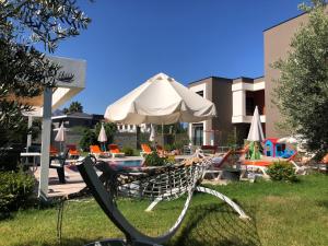 a chair with an umbrella next to a pool at Eva Apart Kemer in Kemer