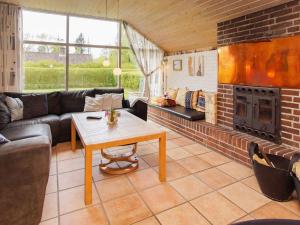 a living room with a couch and a fireplace at 4 person holiday home in Hemmet in Hemmet