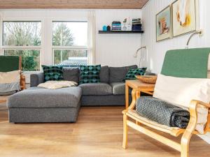 a living room with a couch and chairs at 7 person holiday home in Ebeltoft in Ebeltoft