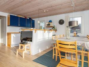 a kitchen and dining room with a table and chairs at 7 person holiday home in Ebeltoft in Ebeltoft