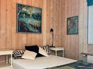a bedroom with a bed and a painting on the wall at 6 person holiday home in Bryrup in Bryrup