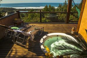 a deck with a swimming pool and a view of the ocean at Solar Mirador Exclusive Resort e SPA in Praia do Rosa