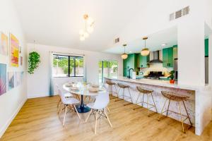 a kitchen and dining room with a table and chairs at Sonoran Stunner Permit# 5058 in Palm Springs