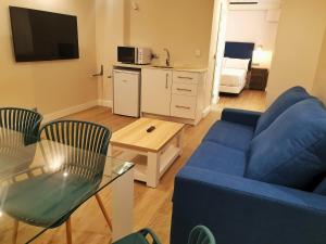 a living room with a blue couch and a table at 4U Hostel in Granada