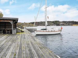 a sail boat is docked at a dock at 4 person holiday home in ELL S in Ellos