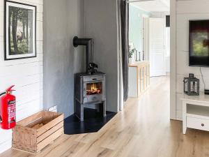 a wood stove in a living room with a fireplace at Holiday home KARLSKRONA III in Karlskrona