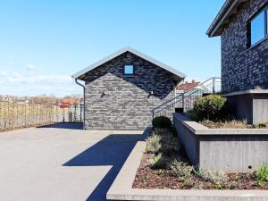 a brick building with a shadow on the side of it at 2 person holiday home in VARBERG-By Traum in Varberg