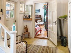 a room with a hallway with a staircase and a room with a table at Holiday home LYCKSELE in Lycksele