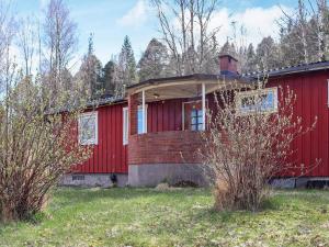 an old red house with a red building at 5 person holiday home in BILLINGFORS in Billingsfors