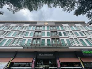 a building with a sign on the front of it at SSL Traders Hotel in Taiping