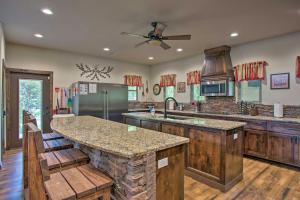 a large kitchen with a large island in a house at All-Encompassing Family Retreat Near Lake Texoma! in Kingston