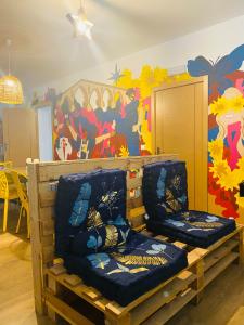 a room with two chairs in front of a mural at Albergue Estrella Guia Solo Peregrinos in Puente la Reina