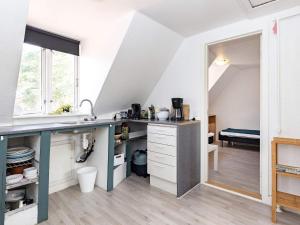 an attic kitchen with a counter and a sink at 3 person holiday home in r sk bing in Ærøskøbing