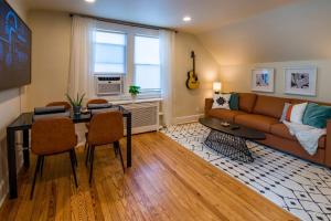 a living room with a couch and a table at Immaculate, Newly Renovated 1 Bedroom Apt Near NYC in Hawthorne