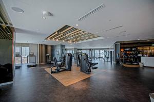 a gym with treadmills and exercise equipment in a building at Opulent Hollywood Styled Flat in Paramount Tower in Dubai