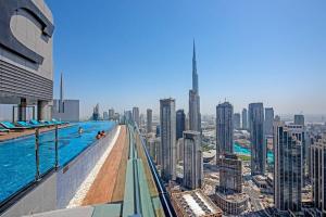 a pool on the top of a building with a city at Opulent Hollywood Styled Flat in Paramount Tower in Dubai