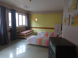 A bed or beds in a room at City Drops Hostel