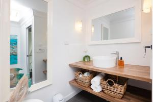 a bathroom with a sink and a mirror at Sand Dunes in Forster +21 photos