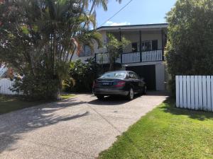 a car parked in front of a house at Redland BayBreeze in Redland Bay
