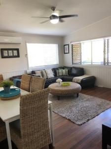 - un salon avec un canapé et une table dans l'établissement Redland BayBreeze, à Redland Bay