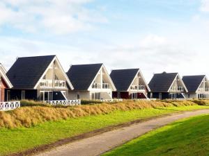 a row of houses on the side of a road at 4 person holiday home in Wendtorf in Wendtorf