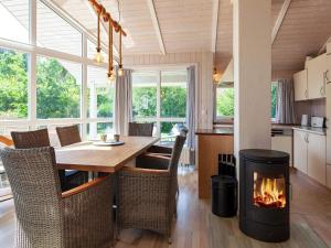 a kitchen and dining room with a fireplace at Three-Bedroom Holiday home in Grömitz 4 in Grömitz